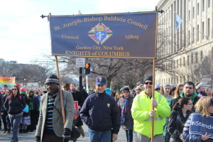 The massive March for Life crowd filled Constitution Avenue to capacity which overflowed onto the avenue’s sidewalks where Aja Nwaeke, John Russo and Donald McCabe found room to steer their banner up to Capitol Hill.